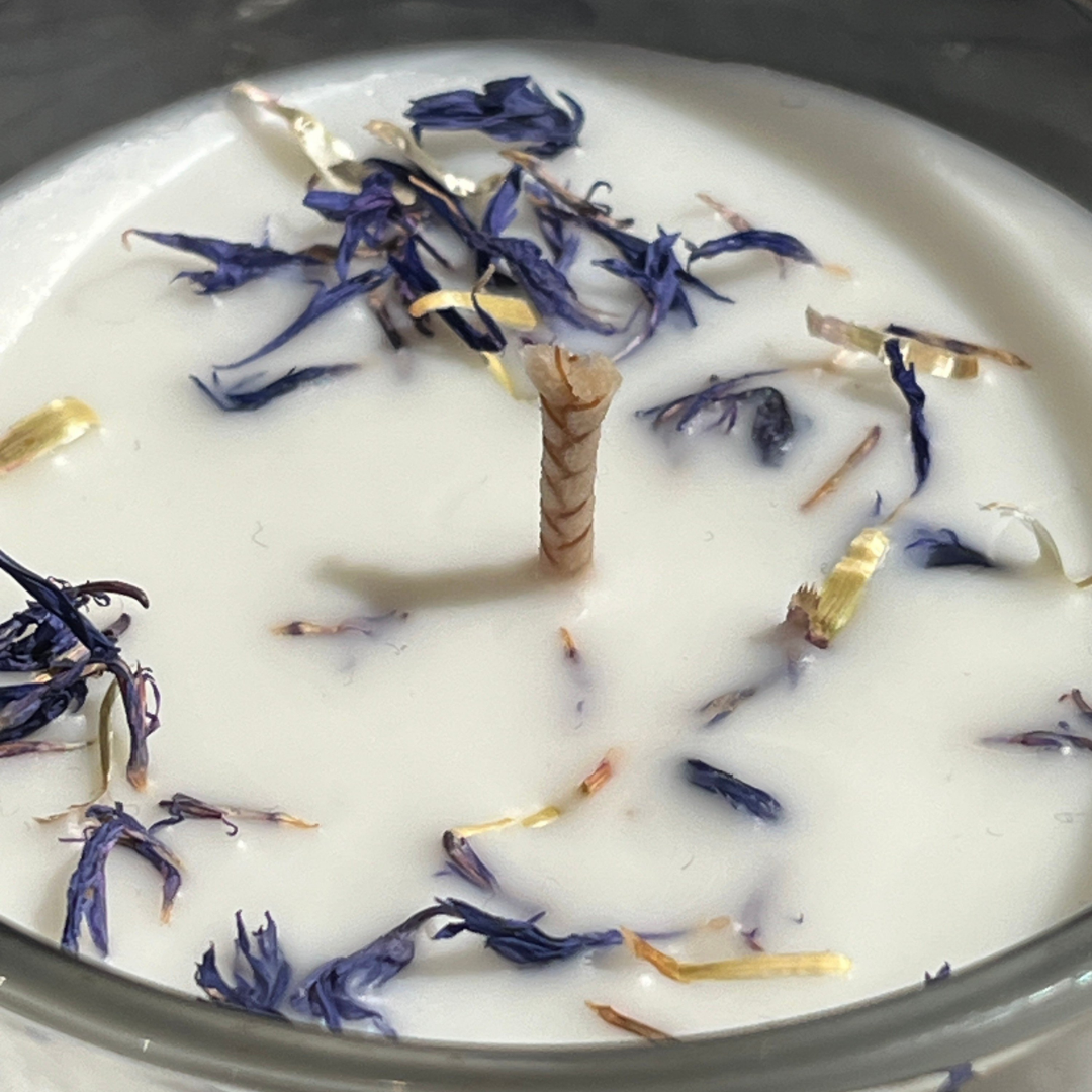 Close up of Peppered Ember candle wax with dried botanicals by Oud Library