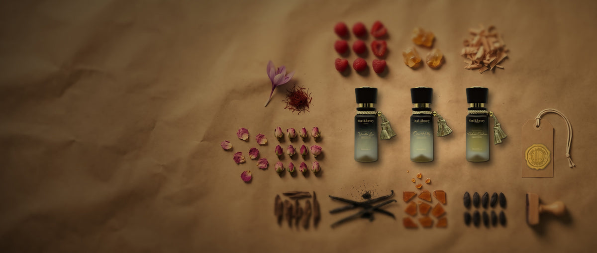 Oud Library Vanilla Lux, One Hubby and Arabian Cashmere 20 ml perfume oils laid on kraft paper with their notes: raspberries, amber, sandalwood, vanilla pods, caramel, tonka beans, saffron, rose buds and oud wood, beside a tag sealed with the Oud Library gold wax seal