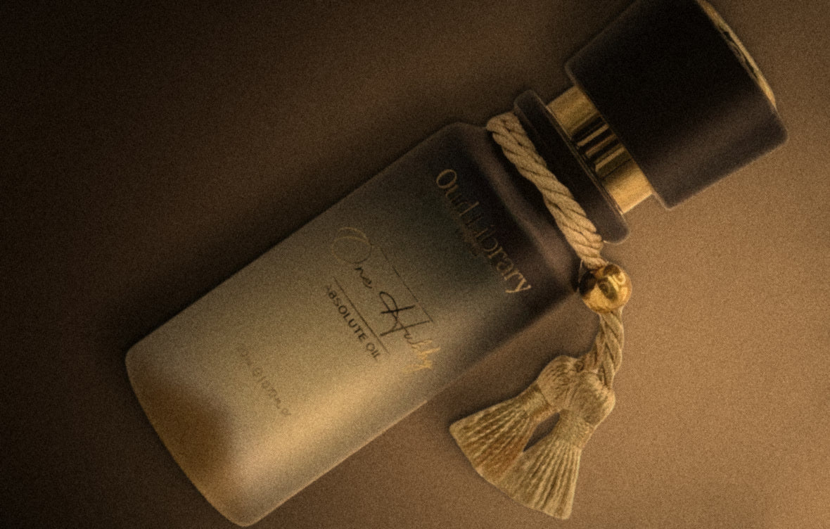 One Hubby Parfum Oil in its new bottle, lying on a warm taupe surface